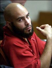 Damien Lewis, 22, sits in his sentencing hearing where he recieved
a 158 year sentence for the double murder of George "Pete" Wallace
and Wyona Chandlee on July 11 2002.