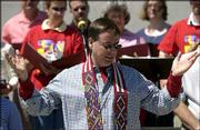The Rev. Darrel Proffitt leads Communion during an outdoor service
Sunday at St. Margaret's Episcopal Church. According to a survey,
St. Margaret's is the second fastest-growing Episcopal parish in
the country.