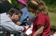 The Rev. Darrel Proffitt blesses Karen Tippett's daughter,
Jacqueline, 3 months, during Communion at St. Margaret's Episcopal
Church, 5700 W. Sixth St.