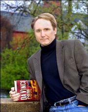 Author Dan Brown poses in his hometown of Exeter, N.H., prior to a
reading from his new book "The Da Vinci Code." The volumn, Brown&squot;s
fourth novel, is a mixture of code-breaking, art history, secret
societies, religion and lore, all wrapped up in a fast-paced
thriller.