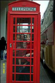 Lawrence Children's Choir members, from left, Jennifer Taylor,
Kristina Taylor, Natalie Rabiola and Lindsay Gauthier clown around
in a London phone booth during the choir's tour in late May/early
June. The choir sang at St. Martin in the Fields, St. Albans
Cathedral and Windsor Parish Chapel during the trip, which
originally was scheduled for the spring of 2002 but was rescheduled
after the Sept. 11, 2001, terrorist attacks made parents
apprehensive about world travel.