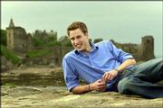 Prince William poses for a photograph on the pier at St. Andrews,
Scotland, in this May 28 file photo, with the castle in the
background. The Prince is two years into a four-year history of art
degree at the Scottish university.
