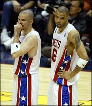 New Jersey's Jason Kidd, left, and Kenyon Martin watch as San
Antonio celebrates a 93-83 win in Game 5 of the NBA Finals. The
Spurs won the game Friday in East Rutherford, N.J.