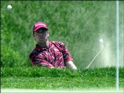 Dicky Pride hits from a bunker on the seventh hole. Pride is six
strokes back after Saturday's round at Olympia Fields, Ill.