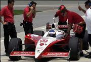 Indy Racing League driver Scott Dixon stops in pit row during
practice at the Kansas Speedway Tuesday.