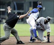 Umpire Larry Poncino, left, calls Minnesota's Torii Hunter, right,
safe at second base under the tag of Kansas City shortstop Angel
Berroa. The Twins beat the Royals, 16-2, Thursday in Kansas City,
Mo.