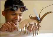 Lawrence Artist Juniper Tangpuz utilizes his smallest paper scraps
to create imaginary creatures like this digging insect which has a
sensory antenna and a blade-like weapon attached to its head. And
the goggles he's wearing? He made those from paper, too.