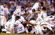 Rice players pile up as they celebrate their College World Series
championship. The Owls won the third game of the championship
series against Stanford, 14-2, Monday in Omaha, Neb.