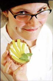 Alison Olewnik, pastry chef and baker at Community Mercantile
Co-op, 901 Iowa, displays a mango cream tart with french cream and
whole wheat crust. Olewnik, the youngest graduate of the American
Institute of Baking in Manhattan, hopes to transform Mercantile's
bakery into a sell-all, do-all pastry shop.