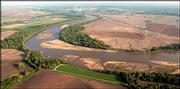 The Kansas River meanders east toward Lawrence northwest of the
Westar Lawrence Energy Center. Federal environmental officials
Monday upgraded the designated use of more than 1,000 bodies of
water in Kansas to be clean enough for humans to fish and swim in
them. The Kansas River is designated "primary contact
recreational," which means it should be clean enough to fish or
swim in, but it often has amounts of bacteria that would make it
unsafe for swimmers.