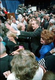 Former Sen. Bob Dole and his wife, Elizabeth, mingle in the crowd
at the "Tribute to Sen. Bob Dole" at Allen Fieldhouse on the Kansas
University campus. The June 1997 event marked Dole's first return
to Kansas after he was defeated by Bill Clinton in the 1996
presidential election.