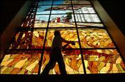 Al Palmer of Stained Glass Overlay of Roseville, Minn., puts the
final touches on a stained-glass window depicting Russell, the
hometown of former U.S. Sen. Bob Dole, at the Dole Institute of
Politics.