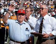 Medal of Honor winner Jack H. Lucas, left, waves to the crowd
during halftime ceremonies at the Southern Mississippi football
game against Army, Oct. 16, 1999, in Hattiesburg, Miss. Lucas, a
private first class during World War II when he received the medal,
was presented with a plaque by USM President Horace Fleming, right,
and Hattiesburg Mayor Ed Morgan, background center. Lucas is
scheduled to attend the dedication of the Dole Institute and speak
at the Memory Tent.