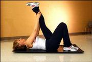 Tight hamstrings are common and can lead to lower-back pain. One
way to stretch the muscle is illustrated in this photo. Lie on your
back with your knees bent. Inhale and extend one leg upward. Exhale
and slowly pull the straight leg toward your face. The straighter
you keep your raised leg, the deeper the stretch.