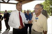 Former Sen. Bob Dole points out the Medal of Honor worn by Robert
Maxwell, Bend, Ore. "Now there&squot;s a hero," Dole said as he and
Maxwell joined other World War II veterans and dignitaries Monday
at a luncheon at the Circle S Ranch north of Lawrence. Maxwell grew
up in Quinter. The largest gathering in years of Medal of Honor
recipients -- 15 -- showed for events surrounding the Dole
Institute of Politics dedication. Eleven of them attended a Memory
Tent presentation Monday morning at the Dole Institute.