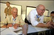 World War II Medal of Honor recipients sign autographs and greet a
crowd of visitors during dedication events for the Dole Institute
of Politics. From left are Walter Ehlers, Buena Park, Calif., and
Hershel Williams, Ona, W.Va. The two participated in a Memory Tent
panel discussion.