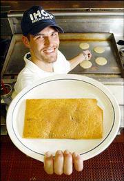 Kansas is actually flatter than a pancake, according to a group of
scientists from Southwest Texas State University and Arizona State
University. In their recently published article, the scientists
analyzed the geography of the state and a pancake purchased at
International House of Pancakes. Saturday in Lawrence, IHOP cook
Edwin Mueller, who displays a pancake in the shape of Kansas, said
he wasn't surprised at their findings.