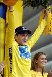 Lance Armstrong waves from the podium after the 19th stage of the
Tour de France. Armstrong placed third in the stage Saturday, all
but securing his fifth straight title.