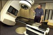 Dr. Mark Edwards, a radiological physicist, explains the properties
of the newly installed linear accelerator at the Lawrence Cancer
Center, located in the Regional Oncology Center at Lawrence
Memorial Hospital. The new device will eliminate the need for
cancer patients to travel to Topeka or the Kansas City area for
radiation treatment.