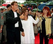 Austria-born actor Arnold Schwarzenegger and his wife, Maria
Shriver, arrive for the German language premiere of his movie
"Batman & Robin" in Graz, Austria, in this June 20, 1997, file
photo. Schwarzenegger has become a national obsession as
speculation swirled on whether he might run for governor of
California. An adviser said Monday that the actor was leaning
against running in the recall election of Gov. Gray Davis.