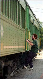 David Donohue, Baldwin, boards a passenger car on the Midland
Railway. The railway is planning rides this weekend on Thomas the
Tank Engine to raise funds to pay for the cost of extending the
railway to Ottawa. Donohue was preparing the cars Tuesday for this
weekend's event.