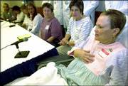 Julia Tower, right, discusses the three-way kidney transplant in
which she was a donor. Joining her Friday at Johns Hopkins Hospital
in Baltimore are, from left, donor Paul Boissiere, recipient
Germaine Allum, recipient Tracy Stahl, donor Connie Dick, and Linda
Warschoff and Ellen Weiser, parents of recipient Jeremy
Weiser-Warschoff, 13.