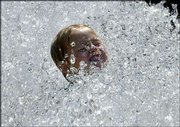 Four-year-old Yannick Nothof cools down in a fountain in Hanover,
northern Germany. Meteorologists expect hot weather to continue for
the next several days in Germany and across Europe.
