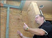 Because of the failed bond issue, Lawrence school officials are now
discussing where the district should focus money to rehabilitate
facilities. Tom Bracciano, the district's director of facilities
and operations, says the plan may be to spend more money in fewer
places. Bracciano was at Lawrence High School Wednesday reviewing
some structural damage to exterior walls, visible at center.