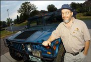 Dave Breggin, head of the Colorado Hummer Club, poses with his 1995
Hummer at his home in Littleton, Colo. Breggin says he can drive
off-road to reach a spectacular view that would take him all day to
hike to.