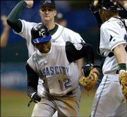 Kansas City's Desi Relaford (12) is sandwiched between Tampa Bay
third baseman Jared Sandberg, back, and catcher Toby Hall in a
fourth-inning rundown. Relaford was tagged out, and the Devil Rays
won, 3-2, Thursday in St. Petersburg, Fla.