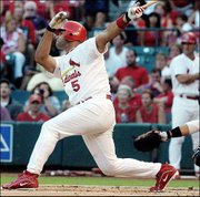 St. Louis' Albert Pujols doubles to score Jim Edmonds in the first
inning. The Cardinals beat the Marlins, 3-0, Thursday in St. Louis.