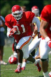 Chiefs running back Priest Holmes carries the ball during practice.
Kansas City has four running backs vying to be Holmes' backup in
2003.
