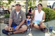 Dennis Blackwood, Lawrence, left, his daughter, Isabelle, 2, and
his wife, Carole, attend Lawrence Memorial Hospital's community
picnic. The picnic was Sunday at LMH South.