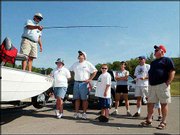 Lawrence fishing guru Chatt Martin, left, demonstrates fishing
techniques. Martin was one of a half dozen vendors who spoke and
sold fishing items Saturday in the marina parking lot for Clinton
Lake Marina Day. The U.S. Coast Guard Auxiliary conducted safety
inspections of boats as part of the day's events. No serious safety
problems were found, Flotilla Commander Shirley Higgins said.