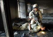 A U.S. soldier arrests an Iraqi man caught robbing the vaults of a
burned-out bank in central Baghdad in this April 16 file photo.
Iraqis say that there is no greater humiliation for an Islamic man
than forcing his forehead to the ground because Islam forbids
putting the forehead on the ground except in prayer. Such Islamic
cultural taboos by the U.S. military are fueling anti-American
sentiment, many Iraqis contend.