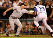 New York first baseman Jason Giambi, left, tags out Kansas City's
Mike Sweeney for the final out in the eighth inning. Giambi was
forced to tag Sweeney when the throw from third baseman Aaron Boone
pulled him off the bag. The Yankees shut out the Royals, 6-0,
Tuesday night at Kauffman Stadium in Kansas City, Mo.