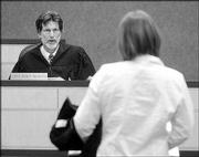 Municipal Judge Randy McGrath, left, addresses Abby at Lawrence
Municipal Court. In February, Mills was charged with minor in
possession of alcohol and failure to pay a speeding ticket.