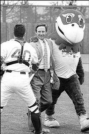 A Jayhawk escorts Kansas University booster Forrest Hoglund,
center, off the Hoglund Ballpark field in 1999. Hoglund threw out
the first pitch during dedication ceremonies.