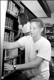 Meghann Maddux and Jen Van Ruyven, St. Catharines, Ontario, help
other Kansas University students find employment through the Career
and Employment Services office at Burge Union. The pair organized
library materials during a cleaning day in July.