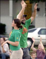 LeeAnn Taylor and Jeff Covitz high-five each other after Covitz
kicked a home run in the top of the fourth inning to give Rudy's
Pizzeria a 5-3 lead in the kickball championship game in South
Park.