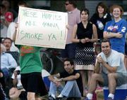 A Rudy's Pizzeria fan carries a sign of support for her kickball
team during the championship game in South Park. The Wattleneck
team defeated Rudy's 9-8 in Sunday's game.