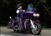 Bonnie Kiefer, 62, from Portsmouth, R.I., rides her 2002 Harley
Davidson Road Glide during a ride with fellow ROMEO (Real Old
Motorcyclists Eating Out) members. Kiefer is part of a growing
number of folks who are spending their golden years grinding
pavement in a motorcycle rather than in an RV. Her Harley, decked
out in purple and silver accouterments, is called "Pegasus."