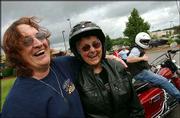 Bonnie Kiefer, left, shares a laugh with fellow motorcyclist Pat
Pinskey, right, 72, from Bristol, R.I. after a meeting of the
Rethreads in Seekonk, Mass. Pinskey and Kiefer both are active
members of the biking community.