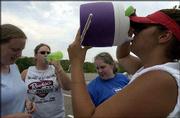 Kansas University marching band piccolo players hydrate themselves
during band practice at the west campus practice field. From left
are Alison Koelper, Shawnee freshman; Lindsey Kinkelaar, Dodge City
junior; Cassie Golden, Overland Park freshman; and Jenny Jaimes,
Overland Park sophomore. The marching band practiced Wednesday in
100-degree weather. Forecasters predict temperatures to top off in
the 80s for Saturday's season football opener at Memorial Stadium.