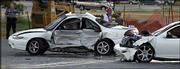 A Lawrence firefighter works behind the cars involved in the fatal
crash near 31st and Iowa streets. Wednesday, Lawrence Police Chief
Ron Olin said police adhered to the department's pursuit policy in
the chase Tuesday that ended with the death of bystander Judith
Vellucci, 56, Lawrence.