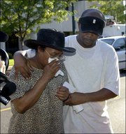 Irene Taylor, left, wife of Robert Taylor, one of the people shot
and killed at an auto parts warehouse in Chicago, leaves the Cook
County Medical Examiner's Office with an unidentified family member
after identifying her husband's body. Five other employees were
also gunned down by a man identified by police as former employee
Salvador Tapia. Tapia was shot to death by police.
