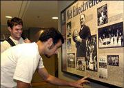 Michael Munden, a sophomore from Mexico City, front, and Tom
Langdon, a senior from Lawrence, check out a basketball display.