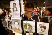 Diaz Dineo, 33, whose father was killed during a crackdown on
rioting imprisoned guerrillas, cries during a vigil in front of the
Palace of Justice in Lima, Peru. After two years of study, Peru's
truth commission released a report on violence between leftist
guerrillas and government security forces, concluding that nearly
70,000 people were killed between 1980 and 2000.