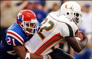 Miami running back Frank Gore (32) is tackled by Louisiana Tech
free safety Michael Johnson. The third-ranked Hurricanes cruised in
their season opener, 48-9, Thursday night in Shreveport, La.