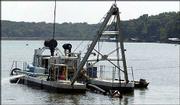 A dredge works to deepen the north end of Lake Dabanawa. The
company's medium-sized dredge is being used for the project to make
the lake more accessible by boats.
